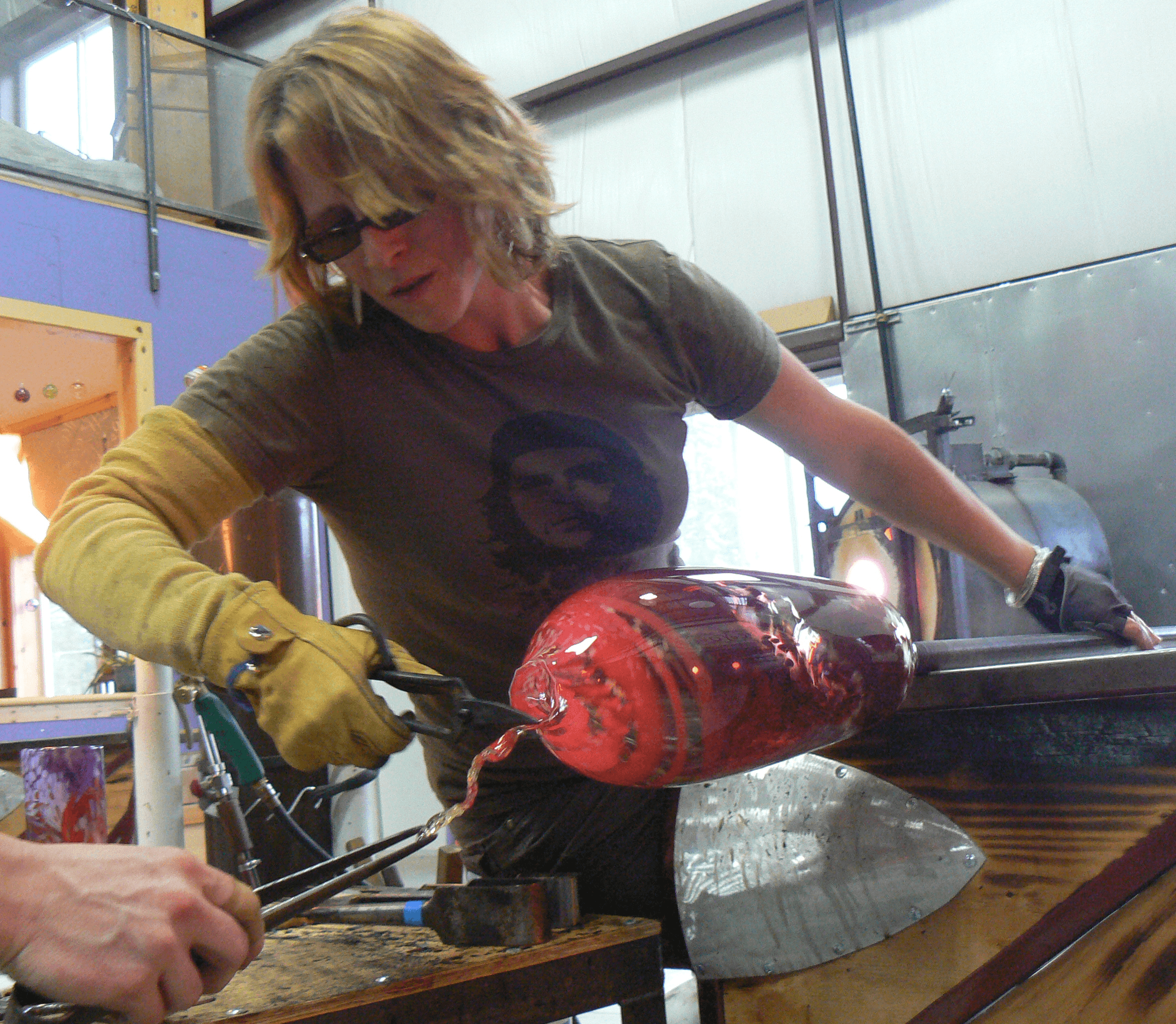 Laurel blowing glass at Glassometry Studios