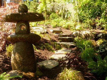 Front yard landscaping transformed by Solstice Landscape Design. Featuring natural stone & a biodiverse mixture of plants.