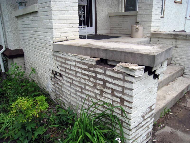 Masonry Fence With Eroding & Cracked Brick