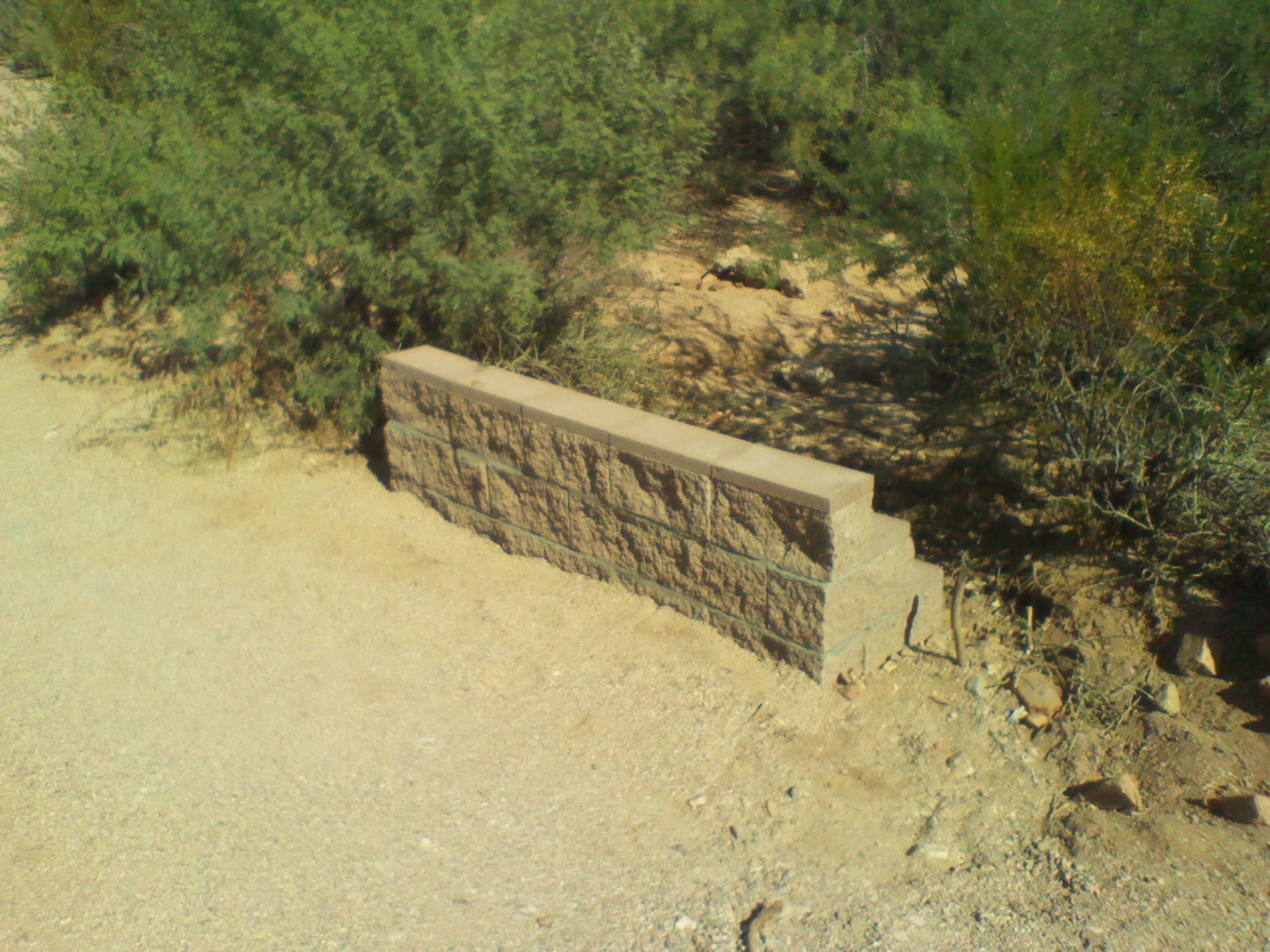 Erosion control wall by driveway