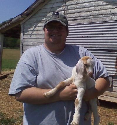 Bobby, one of our pet sitters, with a baby goat! That's right, we can take care of livestock too!