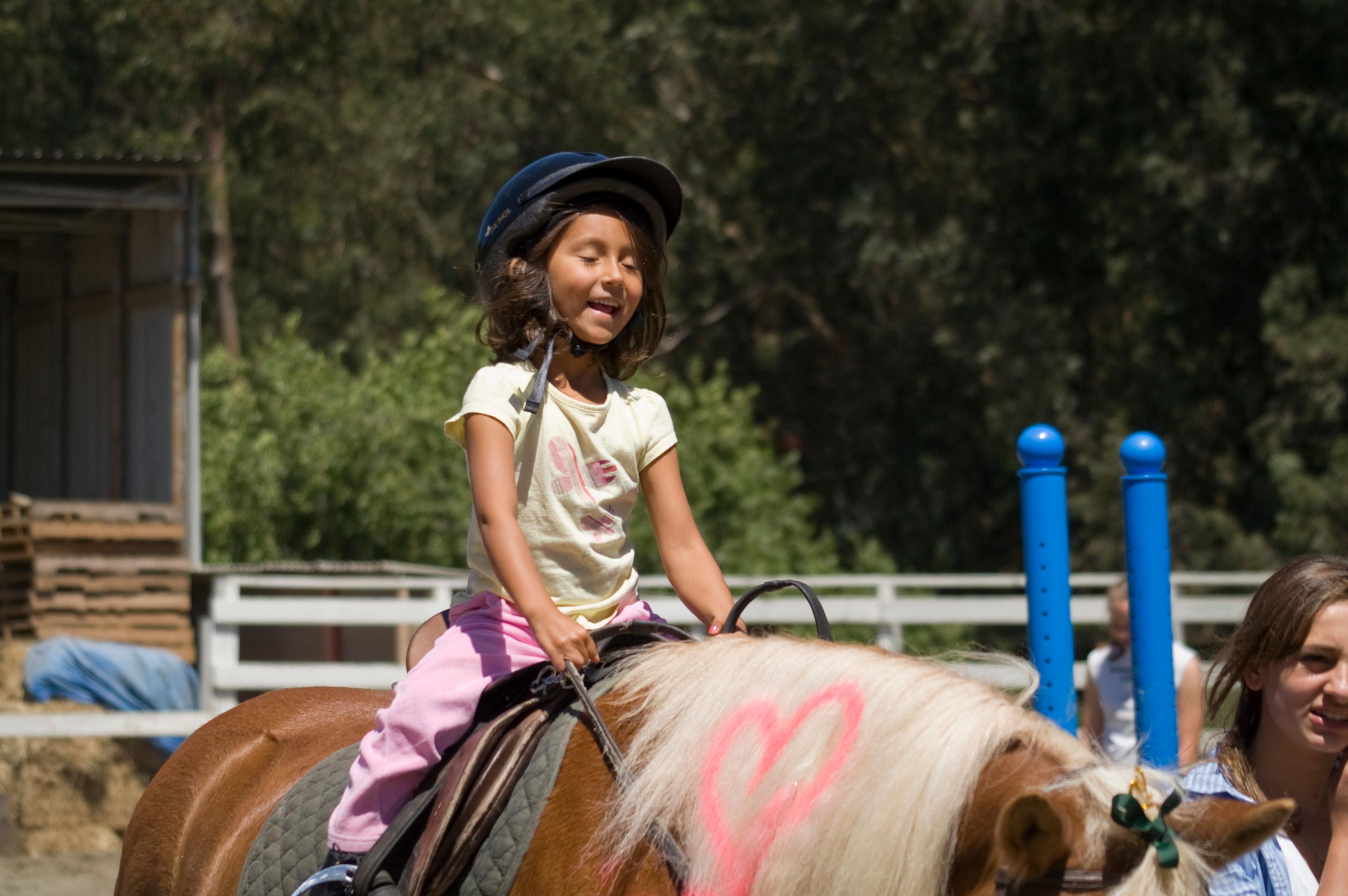 Having fun riding horses.