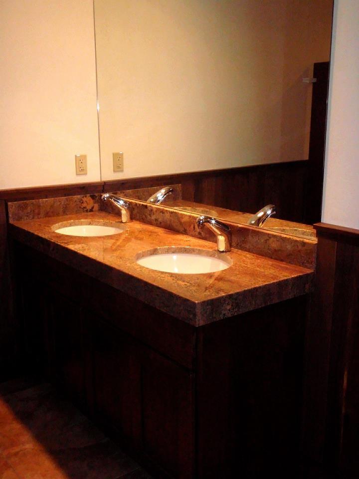 Granite is sturdy enough for even the highest-use, commercial areas like this custom restaurant bath.