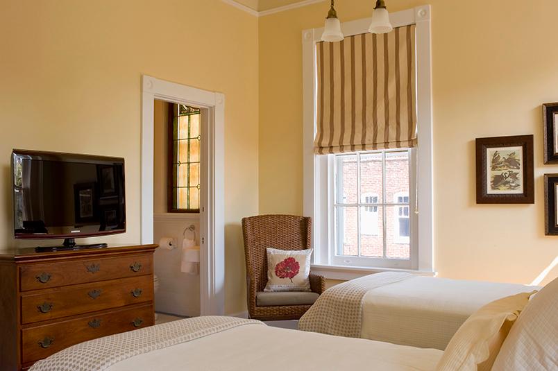 Belmont Suite offers twin beds, heated tile floor in the bathroom, and a private balcony overlooking the pool and gardens