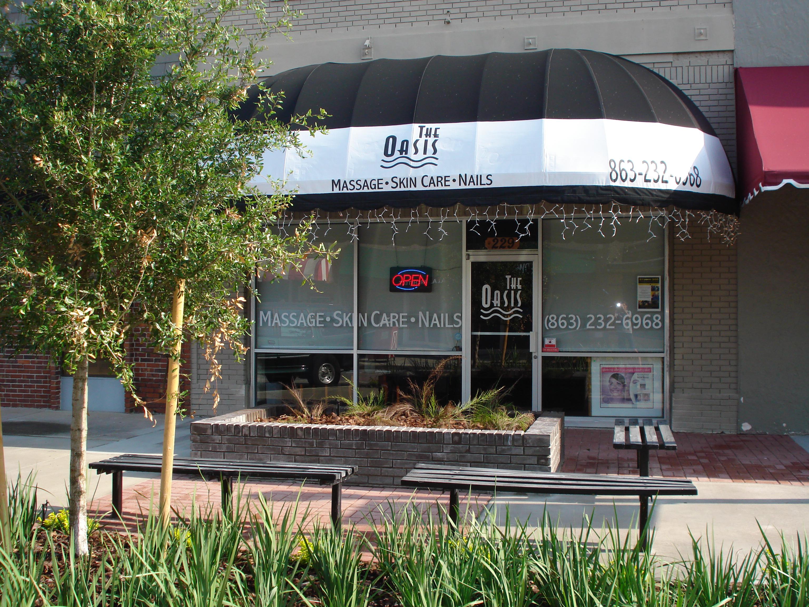 A sidewalk view of The Oasis, we love the benches that are out front at our spa!