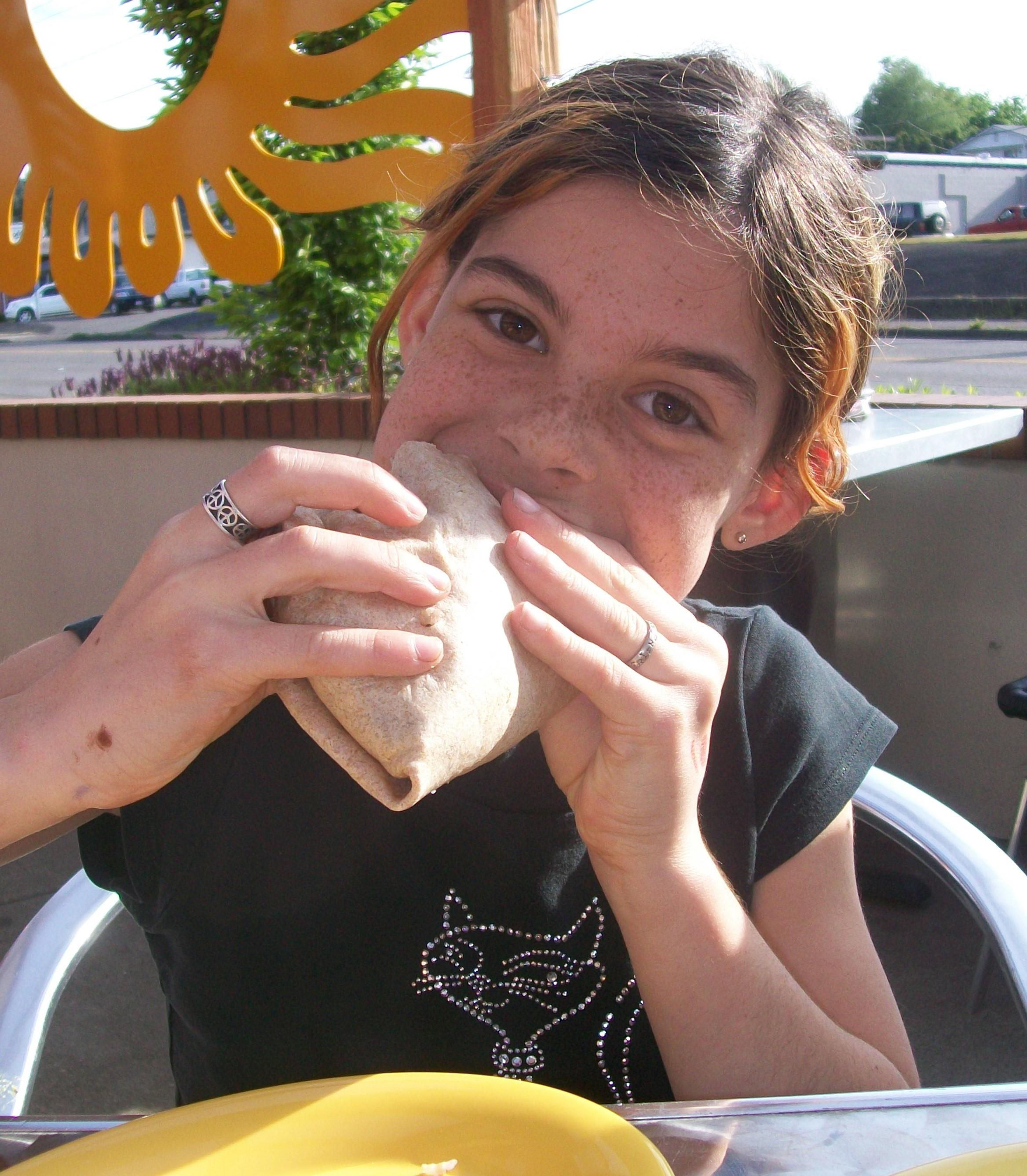 Sophie eats a burrito from the kids menu