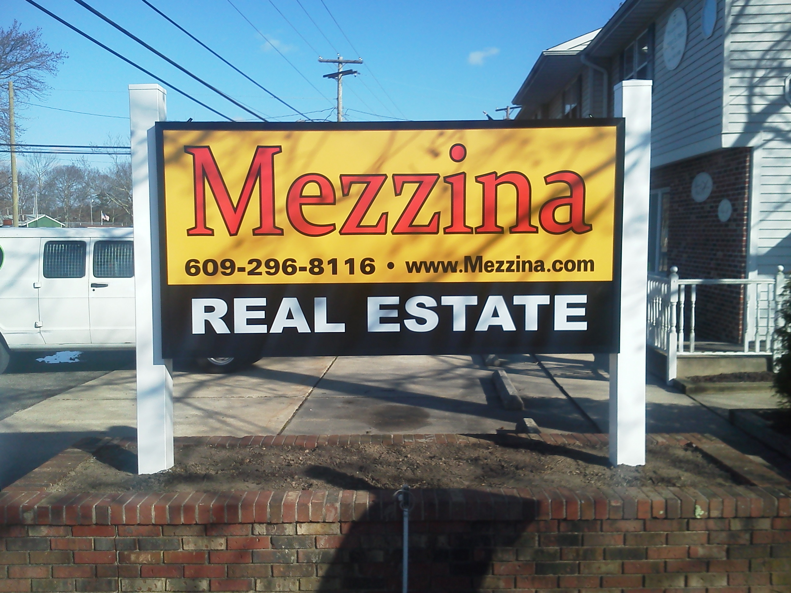 Lighted sign for Mezzina Real Estate LEH, NJ