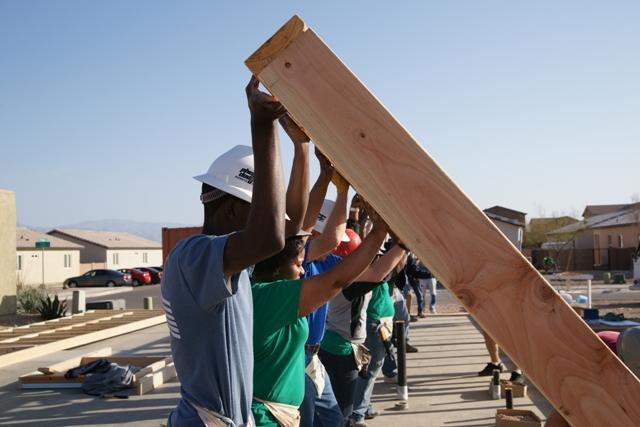 Volunteer raise a wall on a Habitat home!