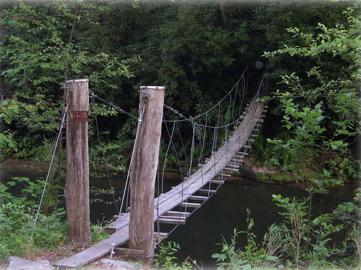 Swinging Wood Bridge adjacent to The Riverfront Cottage.