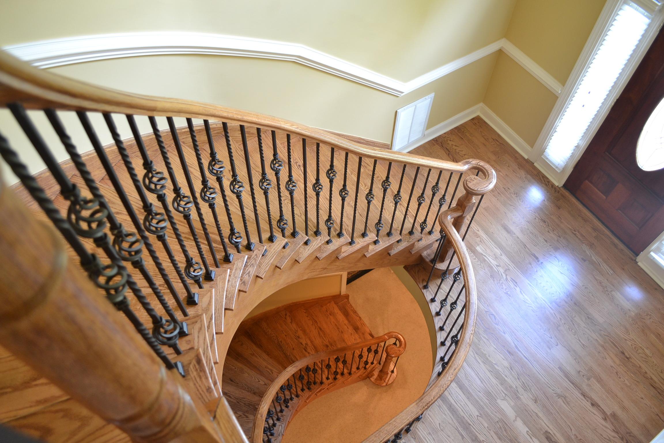 This project included refinishing the floor, stairs, and adding metal balusters. Very cool design!