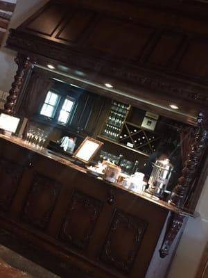 The beautiful carved wood bar