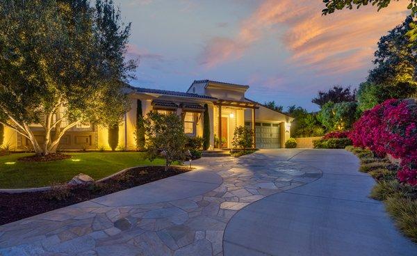 Limestone path welcomes guests to this Spanish villa entryway