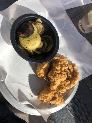 Hand breaded chicken strips and grilled zucchini