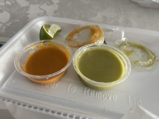 The 2 standard sauces they give you with most orders. The green sauce is very hot; the orange one is mild