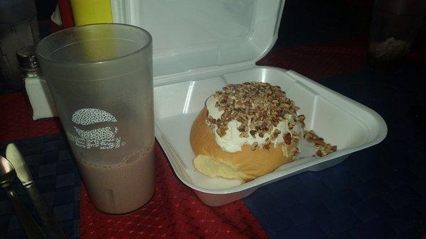 My bottomless glass of milk (1% chocolate) next to my bro-in-laws cinnamon bun to go! This comes with or without the crushed peanuts.