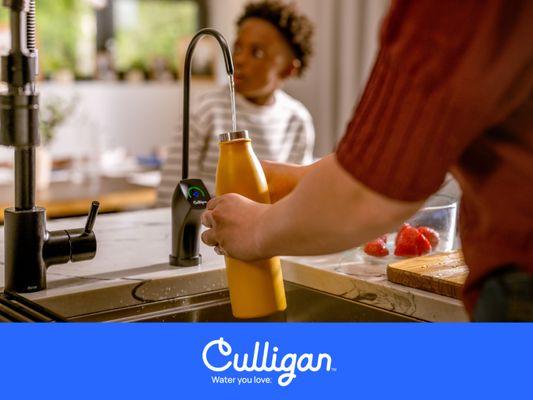 Woman filling water bottle using Culligan RO water