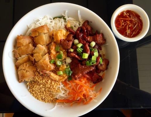 noodle dish with eggroll, shrimp, and grilled pork