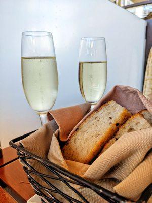 Two champagne glasses and warm focaccia bread