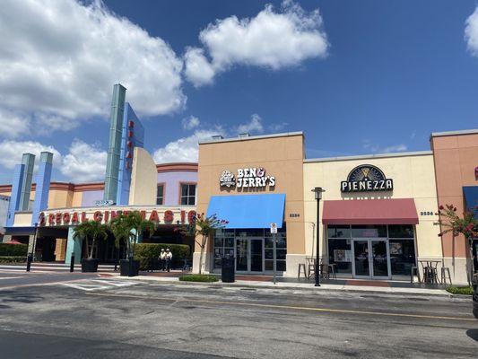 2 shops to the right of the movie theatre