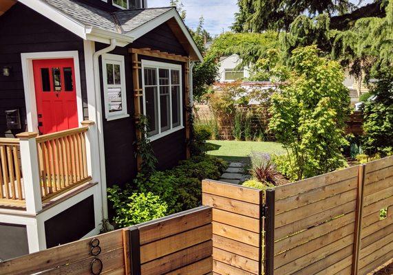 Ballard Green Oasis Framed by Cedar Facing and Steel Post Fence.