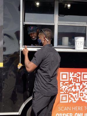 The Nacho Don Food Truck with an employee & customer at the Houston Grub Hub