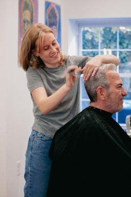 Mandy cutting a customer's hair at Nic Grooming Barber Shop Sansom Street.