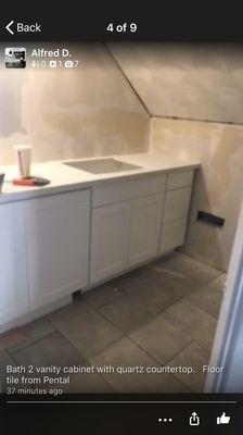 Bath 2 Vanity cabinet with quartz countertop. Floor tile from Pental