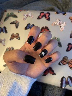 Black gel acrylic nails with a star design