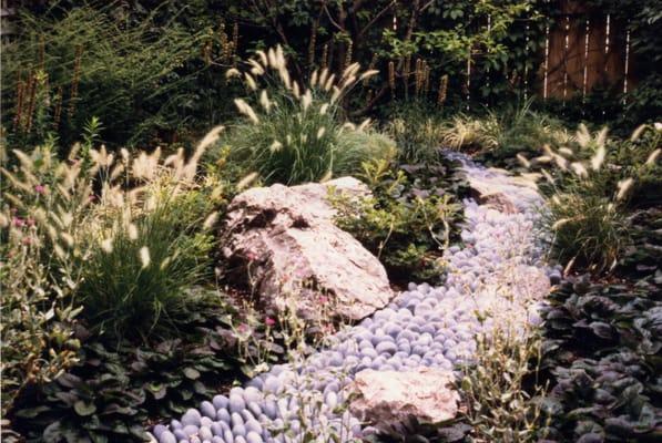 This foreshortened view gives the appearance that the stream vanishes into the background. The large boulder gives more depth.