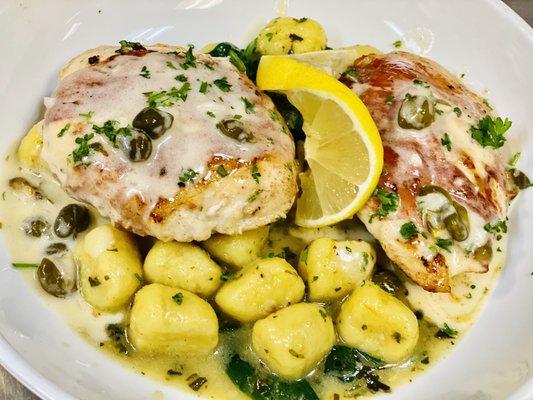 Chicken breast with bacon, stuffed with goat cheese. Served over herbs toasted gnocchi and topped with lemons caper sauce.