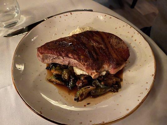 Duroc pork chop with grits and Brussels sprouts.