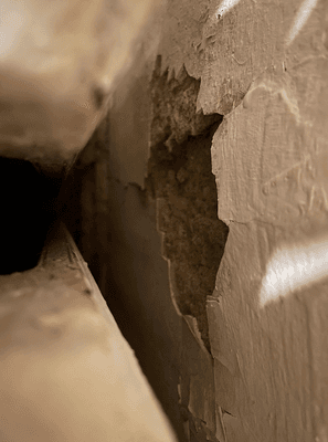 Part of the wall in bedroom #2 that is disintegrating There are a few holes in the walls. This one is slightly larger than a softball.