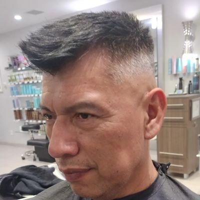 Men's clipper and scissors haircut. Men's grey blending color