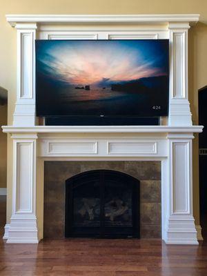 TV mounted above fireplace with LCR Soundbar mounted below