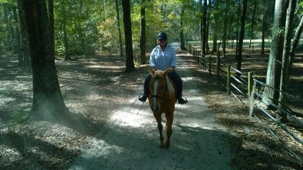 Marianne taking Commander for a ride on trails