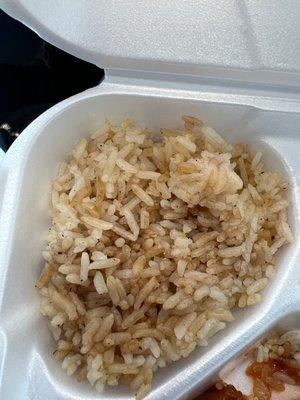 Black particles throughout rice.