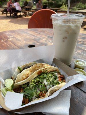 Al pastor taco and the Guaco taco with steak on flour tortillas. Also, the biggest (and best) horchata in town.