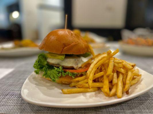 Turkey Burger topped with Mozzarella Lettuce Tomato Avocado and Cucumber