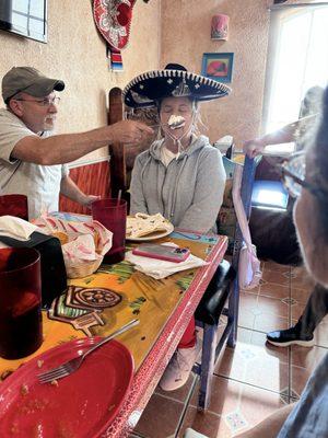 My brother-in-law helping my sister enjoy her birthday sopapilla