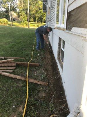 Meagher Pest Control crew digging a trench for a termite control job.