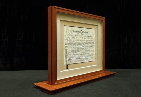 The document is encapsulated in two-sided frame * 2015 Frame design, engineering, and production by Bennett Hall & Eric Linville, Eco Framin