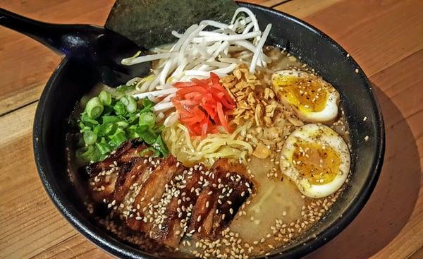 Tonkatsu Ramen, with delicious Pork Belly, red ginger, sesame seeds, bean sprouts, tonkatsu sauce, scallion, garlic chips, and more