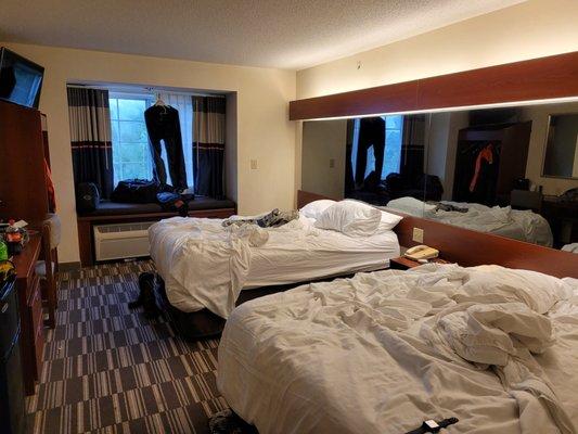 Full wall of mirrors above the beds