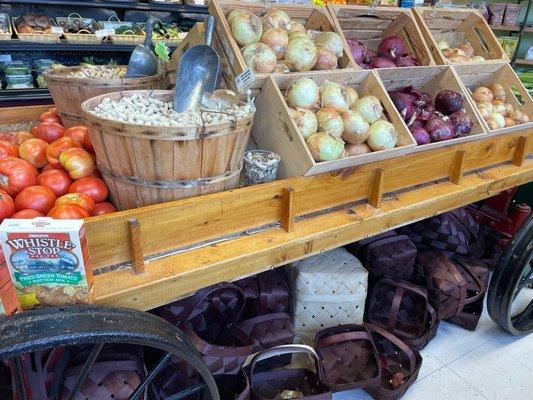 A cart of tomatoes, peanuts, and onions