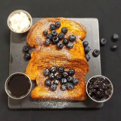 French Toast,  brioche bread, homemade whipped cream, bluberry syrup.