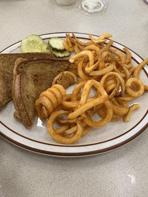 Chilled cheese on wheat, curly fries.