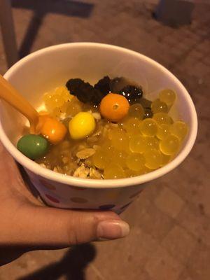 Vanilla yogurt with some boba, granola, brownie bite and m &m