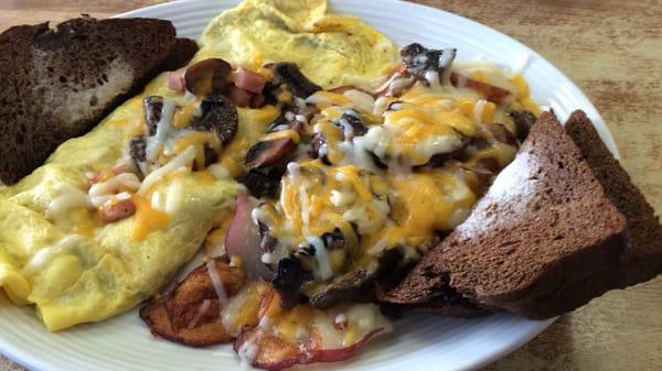 Awesome ham and cheese omelette with mushrooms covered with cheese and rye toast excellent food at the skillet!!