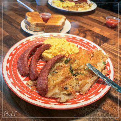 Hawaiian Portuguese Sausage Breakfast plate with home fries, scrambled eggs, and toast. - yum!