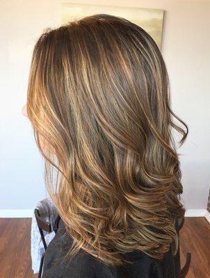 Brunette with full caramel highlights.